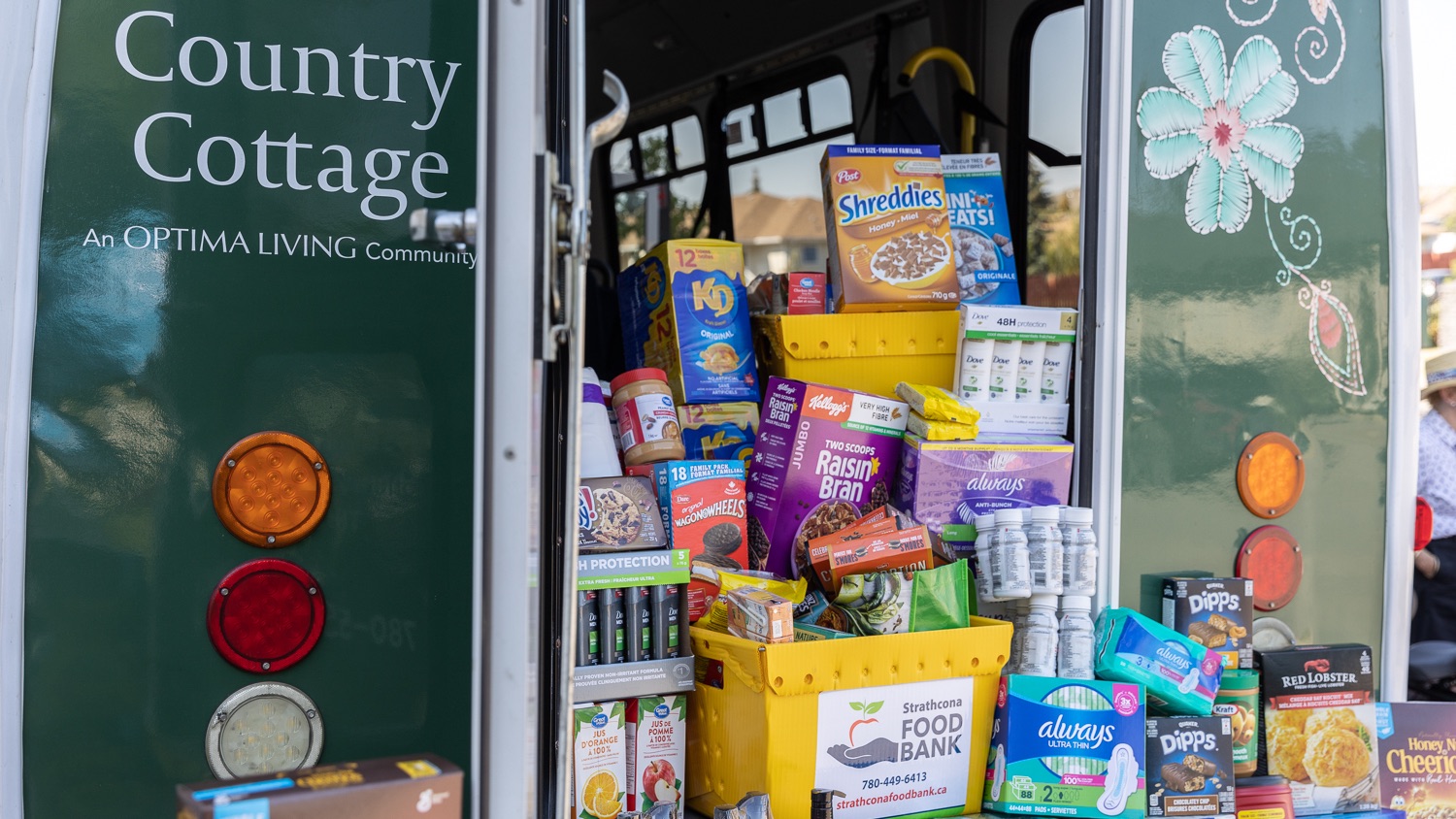 Country Cottage bus back opened with a pile of food for the food bank.