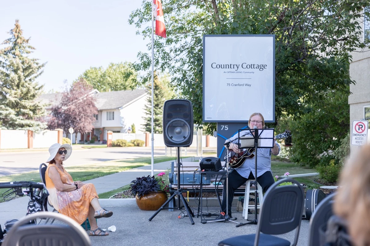 Musician playing and singing for the residents of Country Cottage.