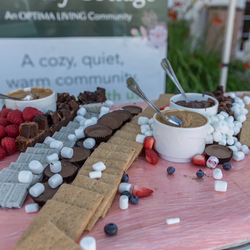 Some s'mores with peanut butter, chocolate, and marshmallows on a table.