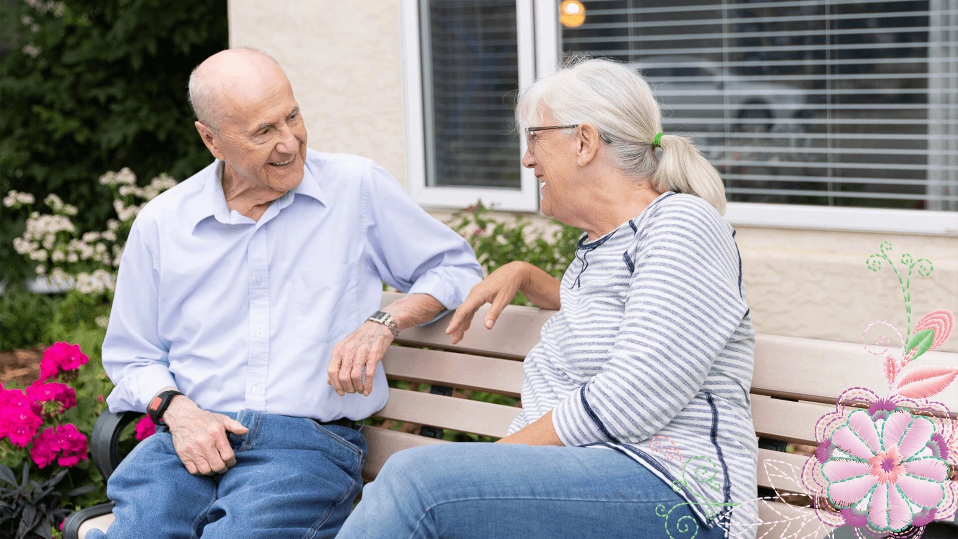 An elderly couple talking and smiling while sitting outside
