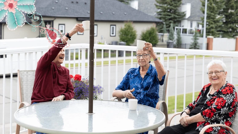 A group of elderly women enjoying together while having coffee