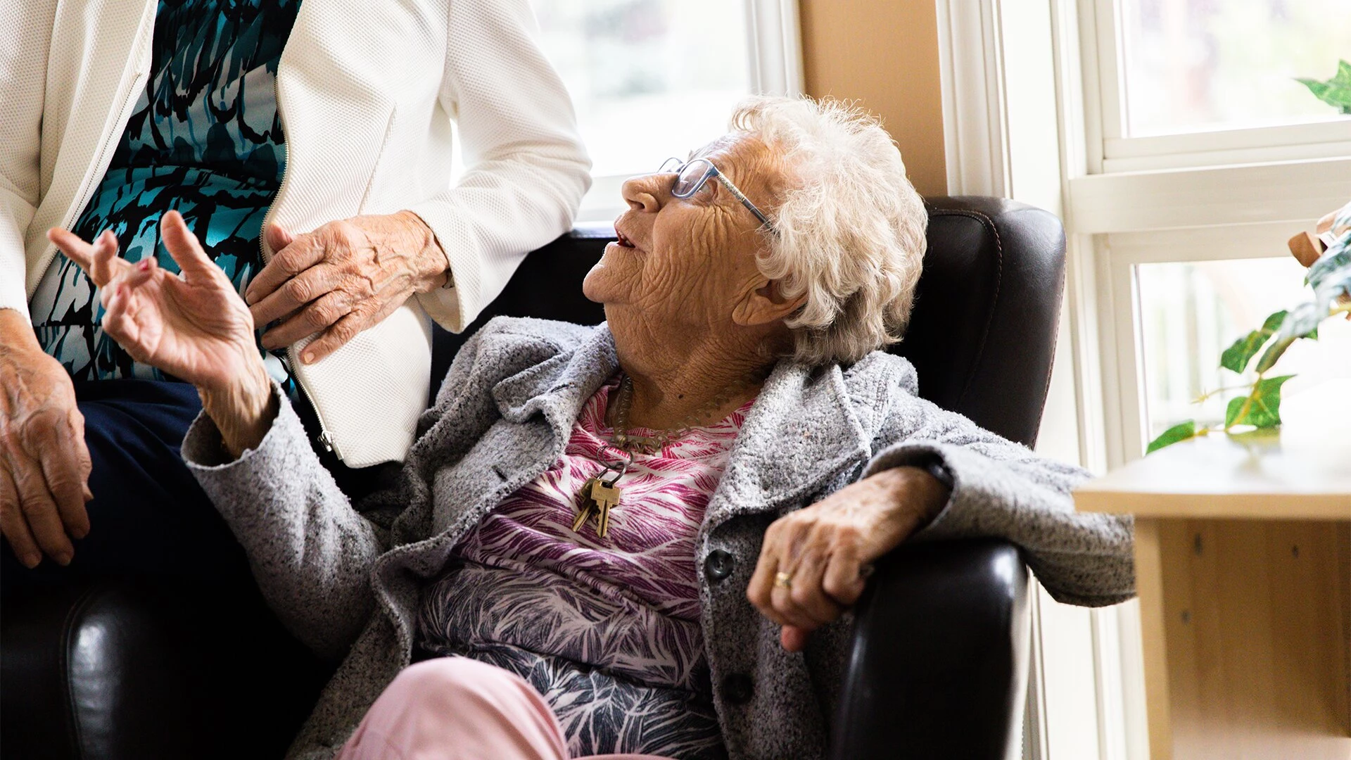 An elderly women sitting on sofa