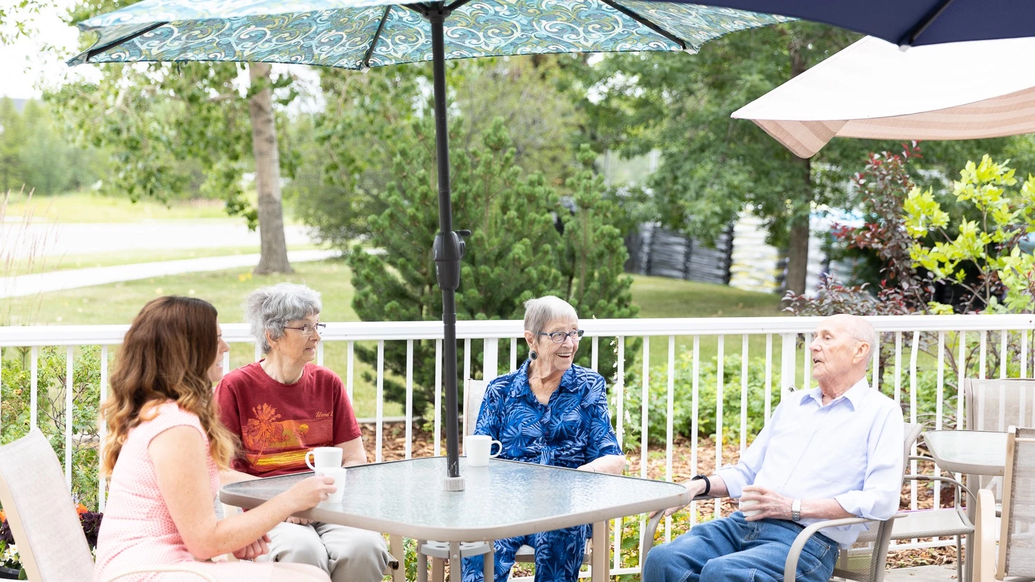 seniors sitting at a patio table talking