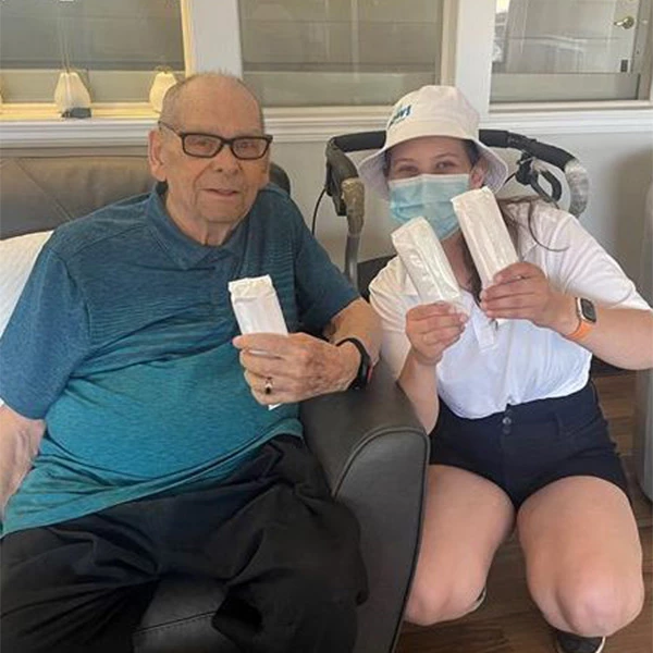 Senior smiling while holding some ice cream treats