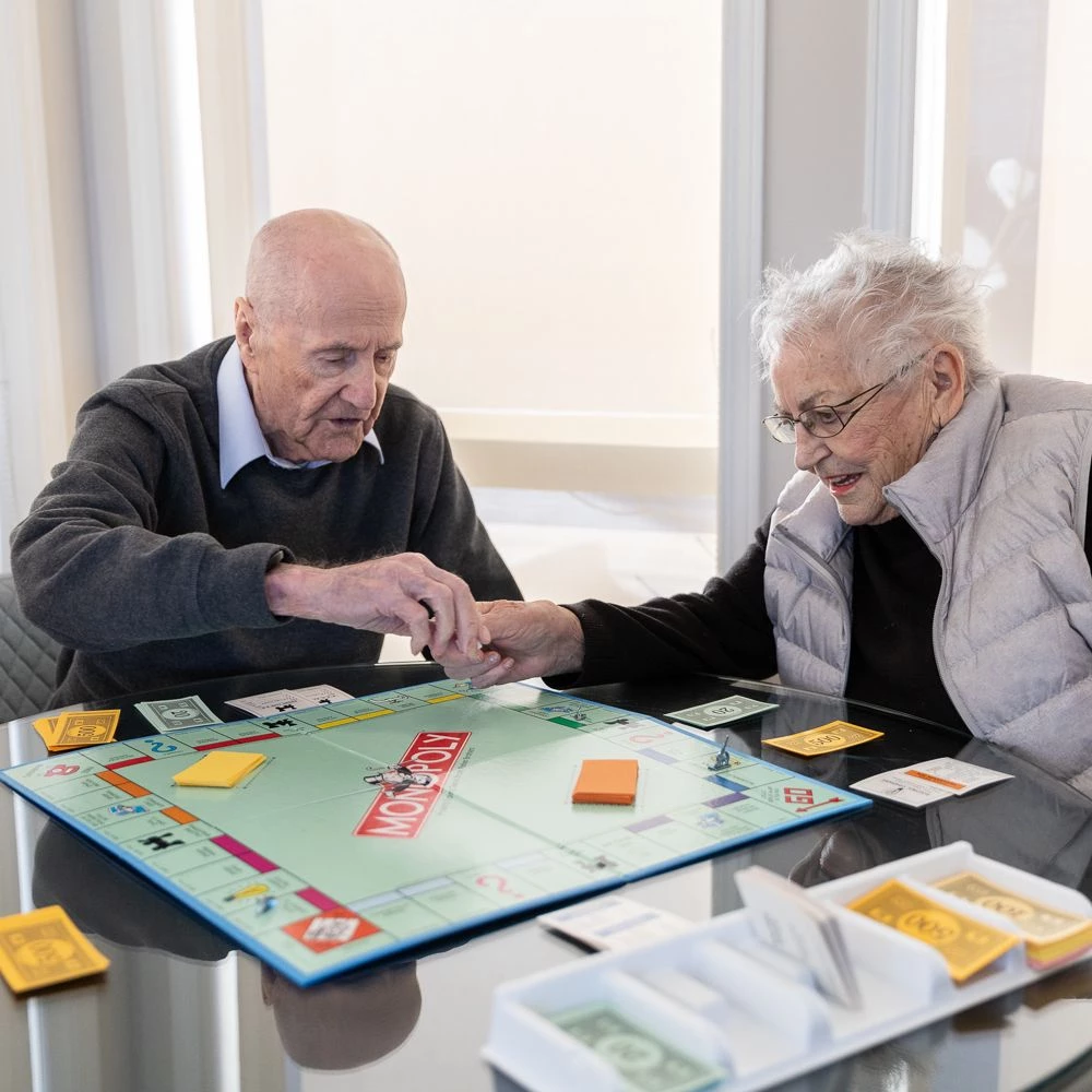 Two seniors playing Monopoly together