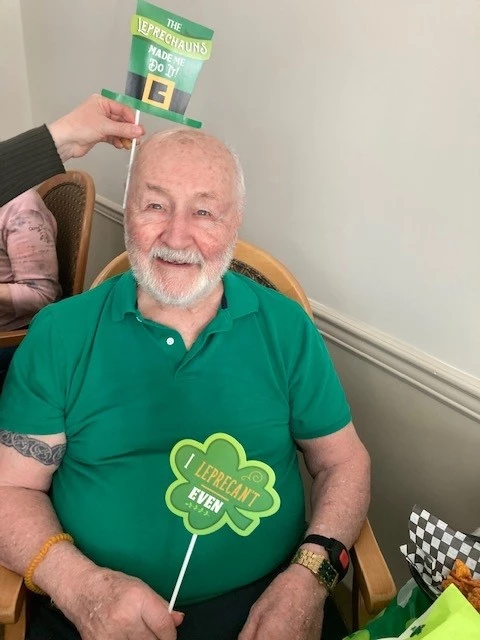 Senior in green with a couple St. Patrick's Day decorations
