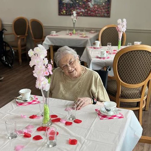 Senior seated at a table